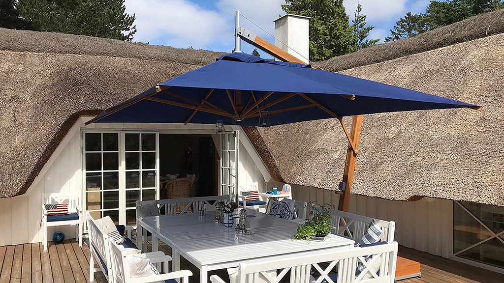 Navy blue canopy on a wooden cantilever parasol