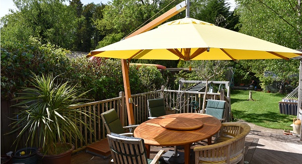 yellow canopy on a wooden cantilever parasol